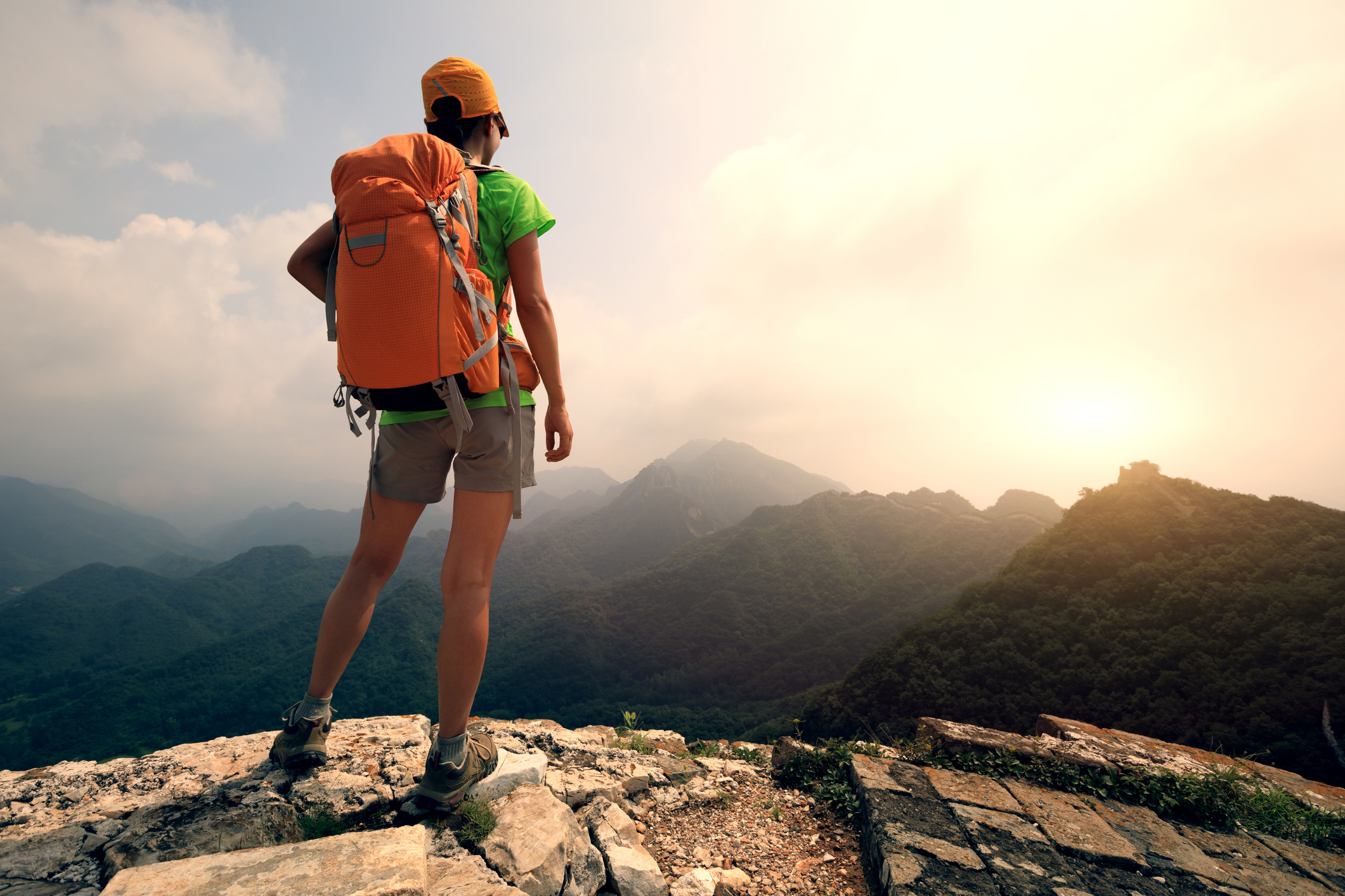 successful woman hiker enjoy the view on the top of great wall